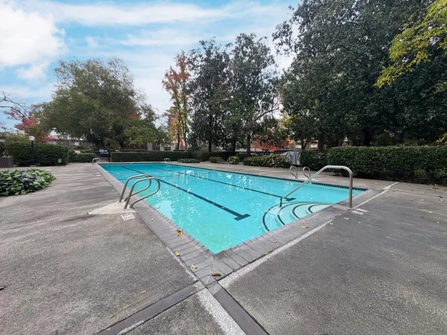 a view of a swimming pool with an outdoor space and seating area