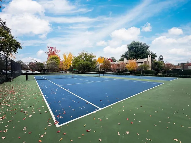 a view of a swimming pool with a patio in the backyard