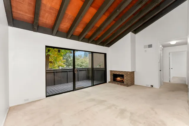 a view of empty room with a fireplace