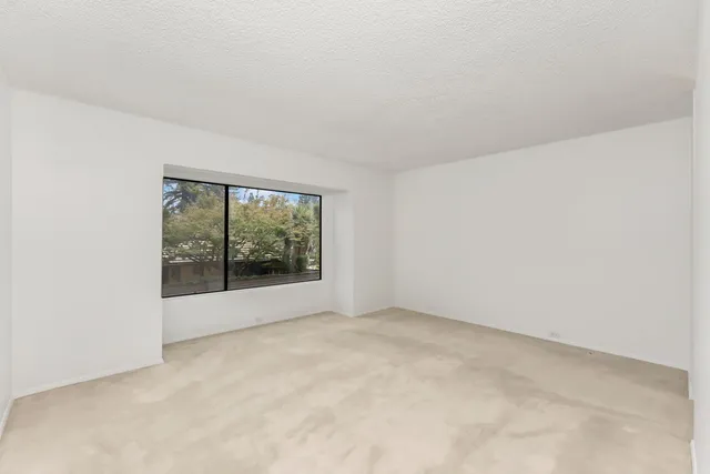 an empty room with floor to ceiling window