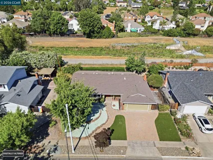 an aerial view of residential houses with outdoor space and river