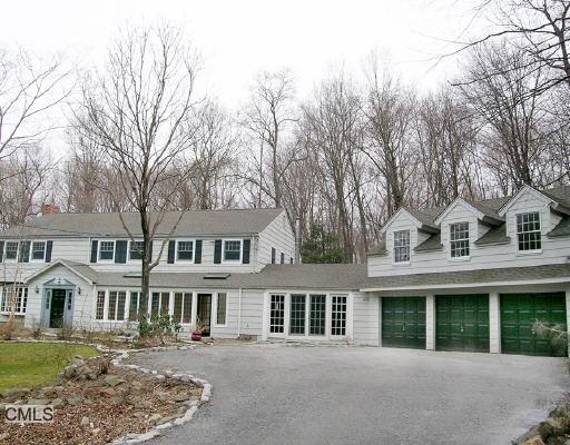 55 Hillcrest Park Road Greenwich, CT 06870 - Photo 1 of 1 a front view of a house with a garden
