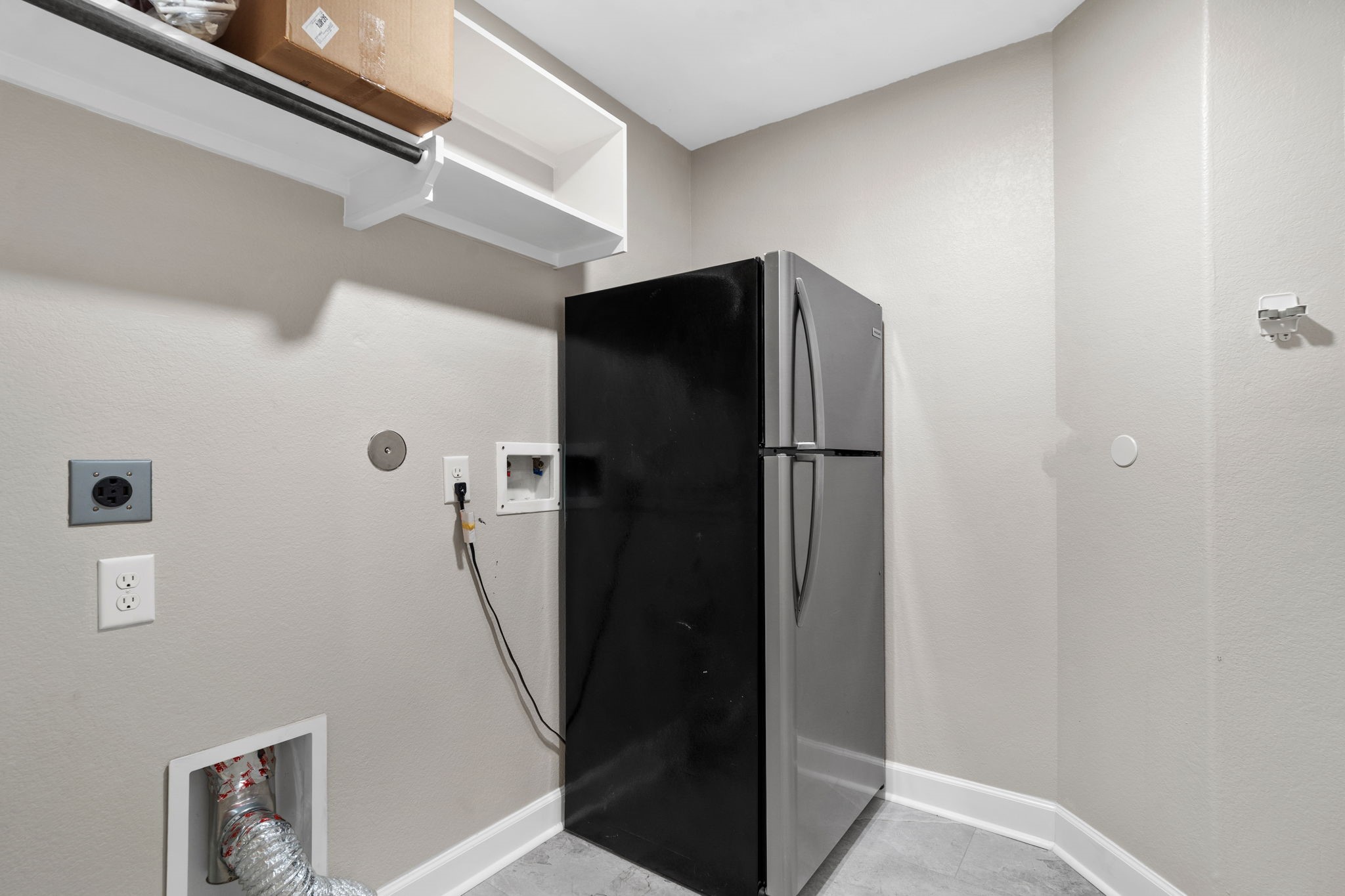 3426 Summer Ranch Drive Katy, TX 77494 - Photo 31 of 48 The utility room is equipped with built-in shelving and space for full-size appliances, creating a practical area that keeps household tasks organized and efficient.