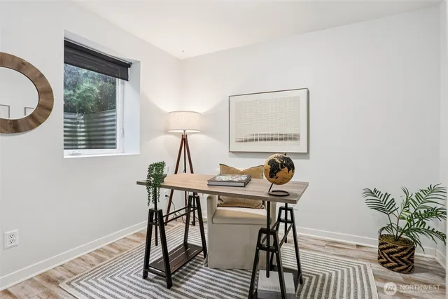 a view of a workspace with furniture and a potted plant
