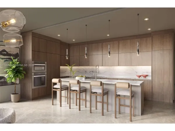 a kitchen with stainless steel appliances kitchen island granite countertop a refrigerator and a stove