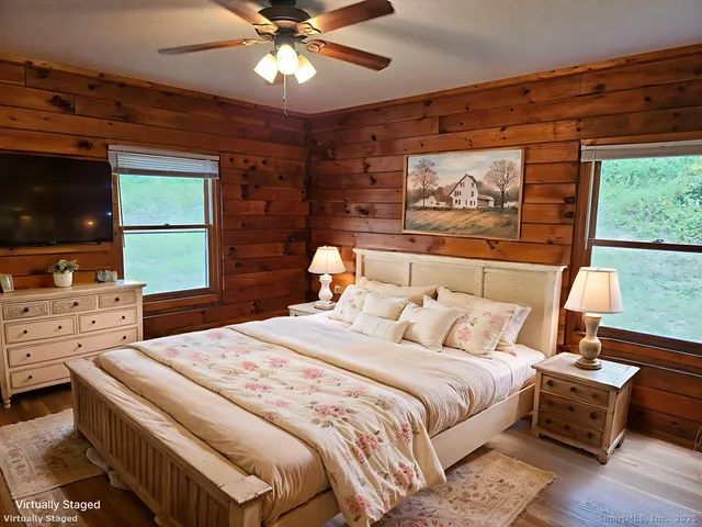 a bedroom with a bed and a flat screen tv