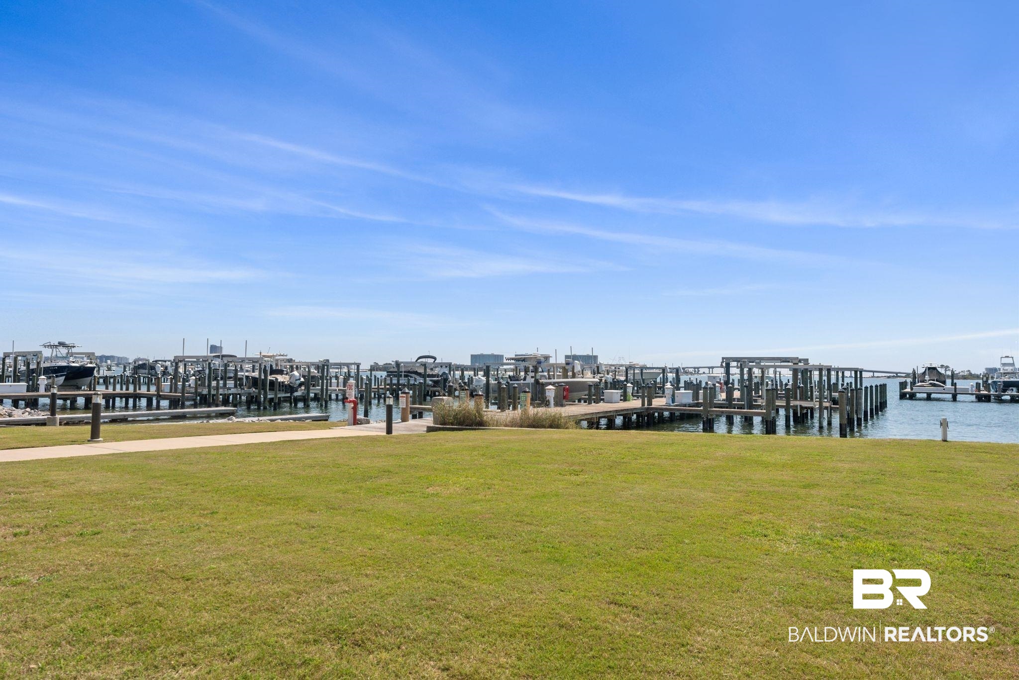 27580 Canal Road, Unit 1233 Orange Beach, AL 36561 - Photo 73 of 79 Dock area featuring a lawn, boat lift, and a water view