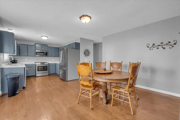 a view of a dining room with furniture and a kitchen