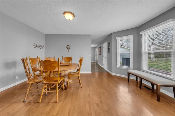a dining room with furniture and wooden floor