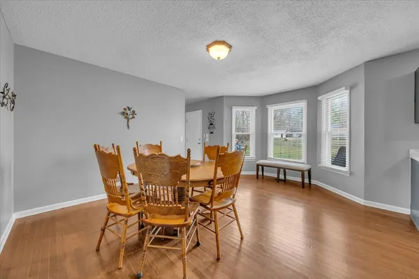 a dining room with furniture and wooden floor