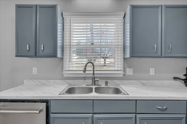 a kitchen with a sink and cabinets