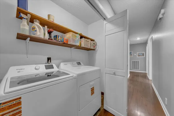 a bedroom with a bed lamp closet and window