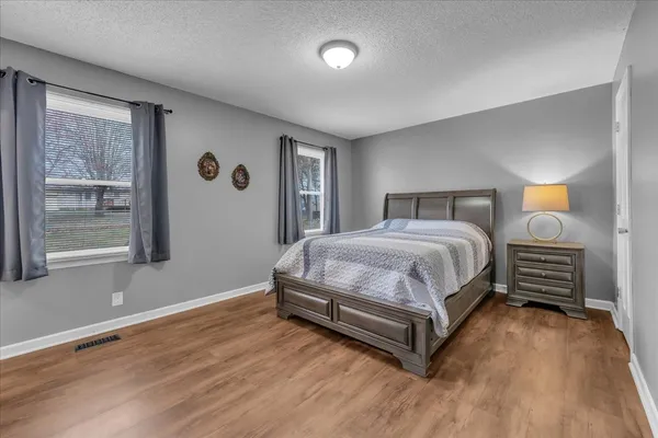 a bedroom with a bed and flat screen tv