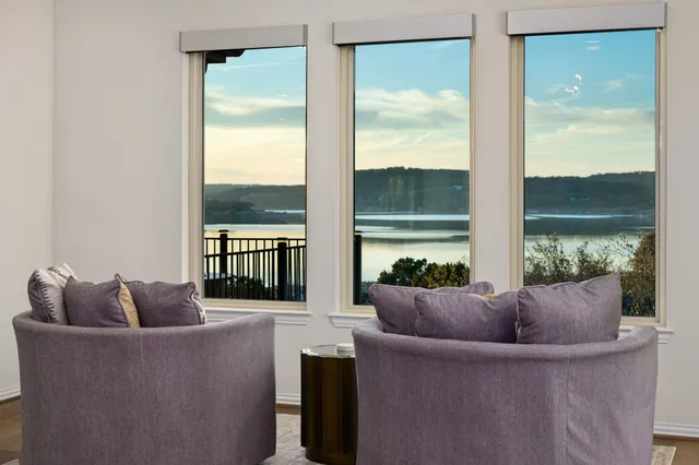 a living room with furniture and a floor to ceiling window