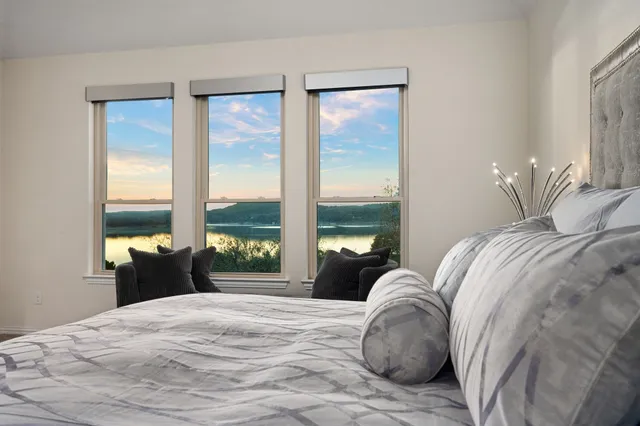 a bedroom with a large bed and a large window