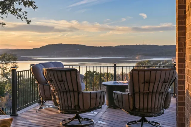 a view of a roof deck with wooden floor and city view