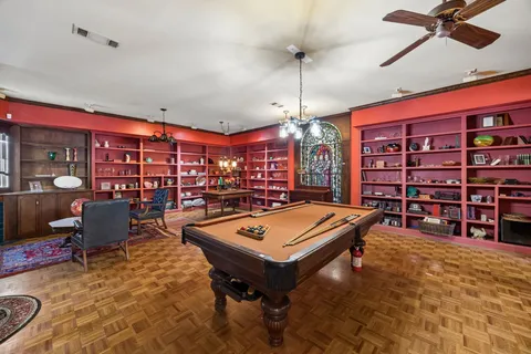 a living room with lots of furniture and chandelier