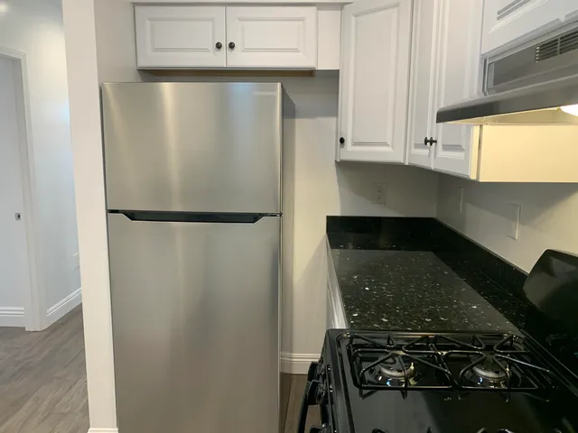 a close view of a stove top oven and cabinets