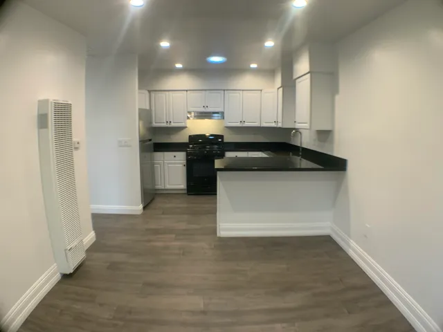 a kitchen with a sink stainless steel appliances and cabinets