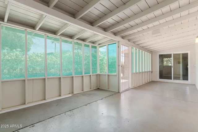 a view of an empty room with windows