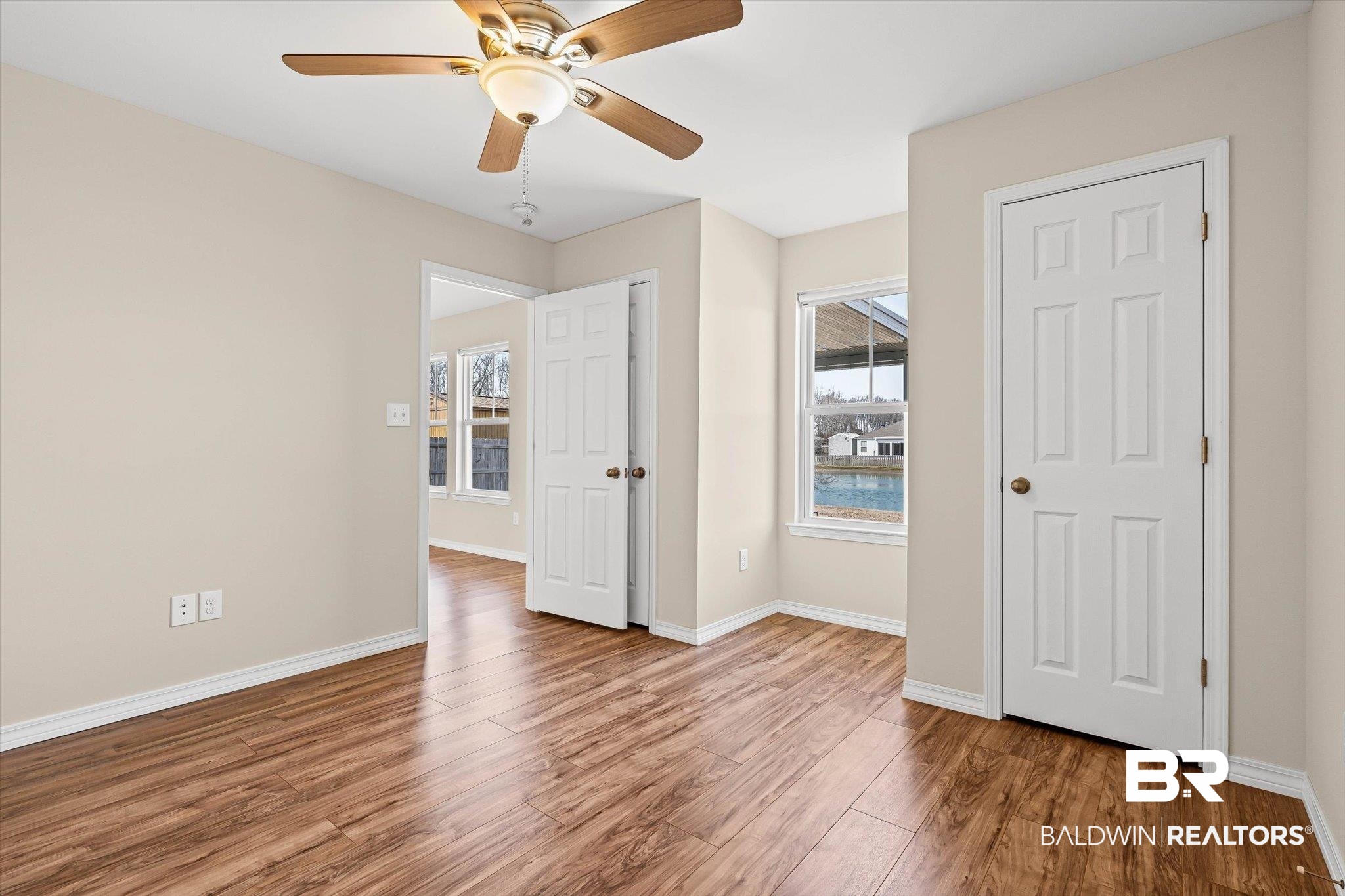 919 Sailor Circle Foley, AL 36535 - Photo 16 of 24 Unfurnished bedroom with wood finished floors, ceiling fan, and two closets