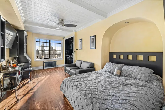 a bedroom with a bed a couch and dresser