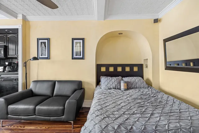a bedroom with a bed and wooden floor