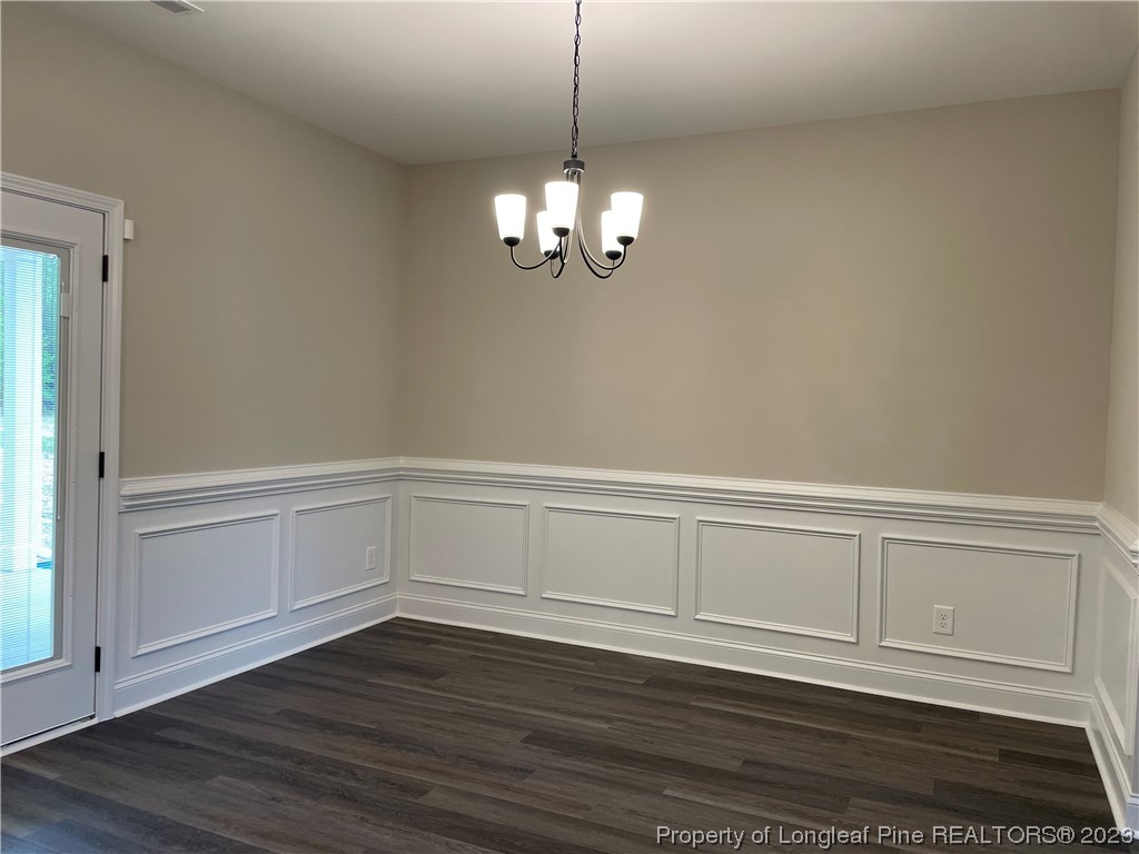 184 Solomon Drive Cameron, NC 28326 - Photo 3 of 13 a view of an empty room with wooden floor and a window