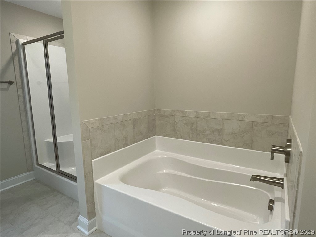 184 Solomon Drive Cameron, NC 28326 - Photo 8 of 13 a white bath tub sitting next to a shower