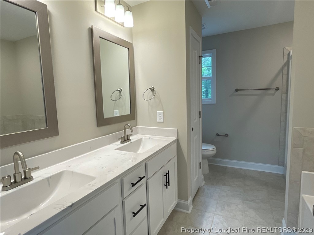 184 Solomon Drive Cameron, NC 28326 - Photo 9 of 13 a bathroom with a granite countertop sink mirror and a toilet