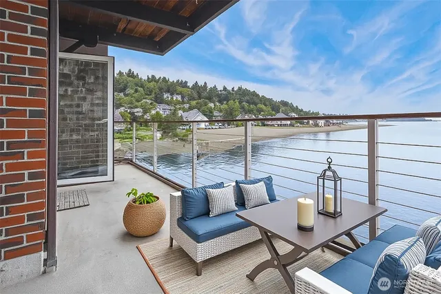 a view of a balcony with chairs and a potted plant