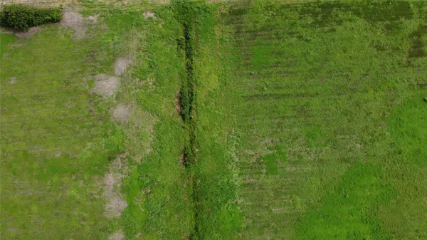 an aerial view of a houses with outdoor space