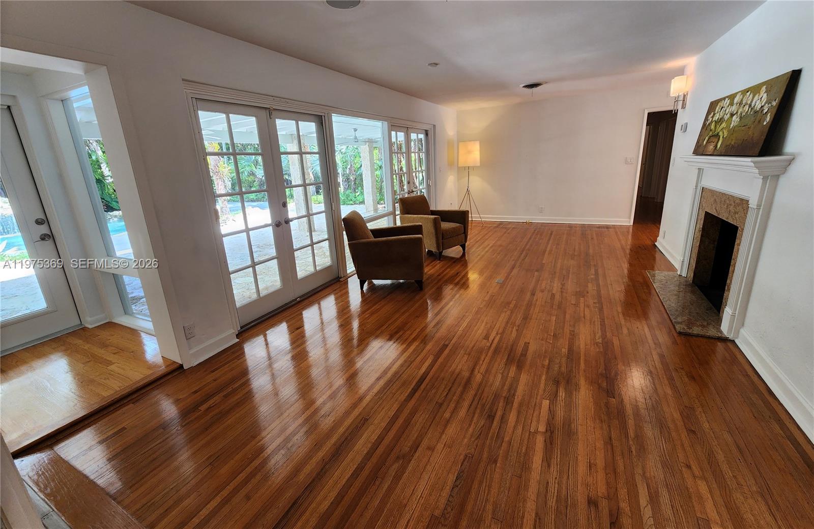 6065 Southwest 133rd Street Pinecrest, FL 33156 - Photo 11 of 41 a living room with furniture and a fireplace