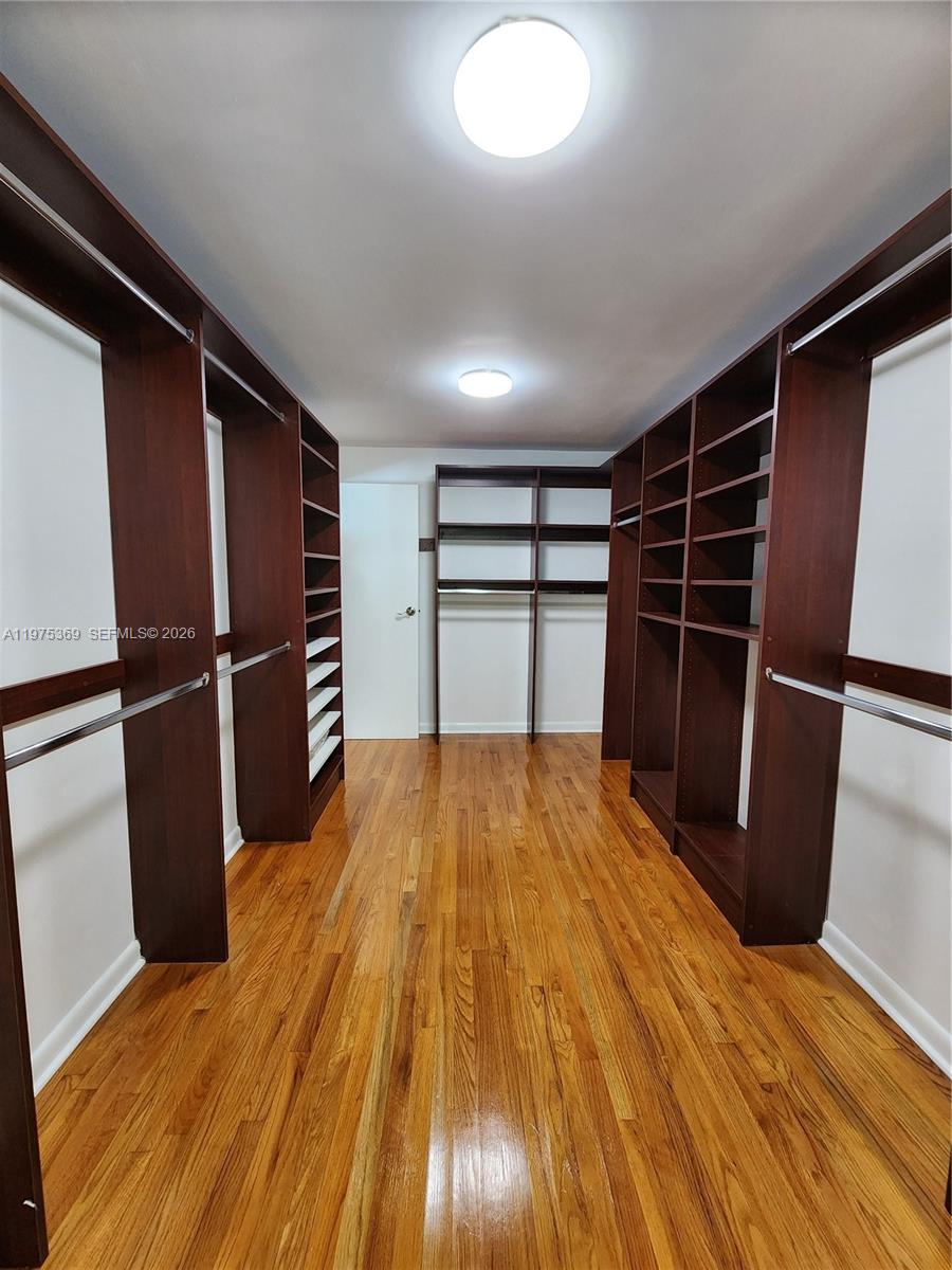 6065 Southwest 133rd Street Pinecrest, FL 33156 - Photo 15 of 41 a view of empty room with wooden floor and cabinet