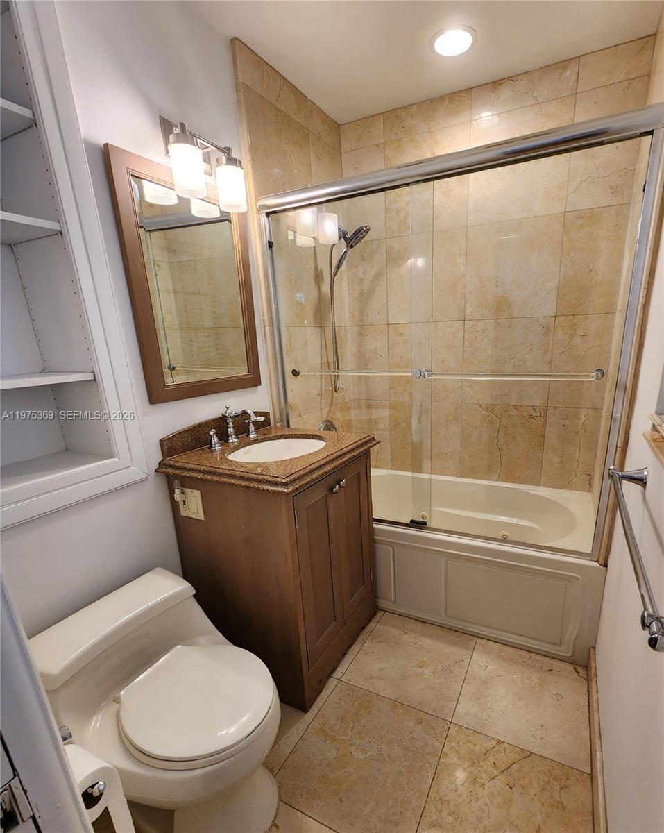6065 Southwest 133rd Street Pinecrest, FL 33156 - Photo 19 of 41 a bathroom with a granite countertop sink toilet and shower