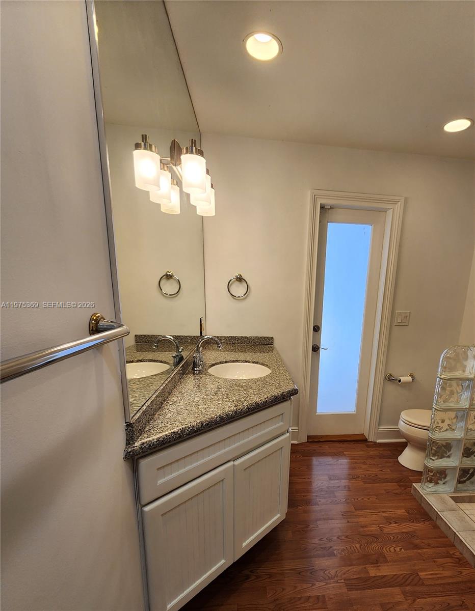 6065 Southwest 133rd Street Pinecrest, FL 33156 - Photo 20 of 41 a bathroom with a granite countertop sink and a mirror