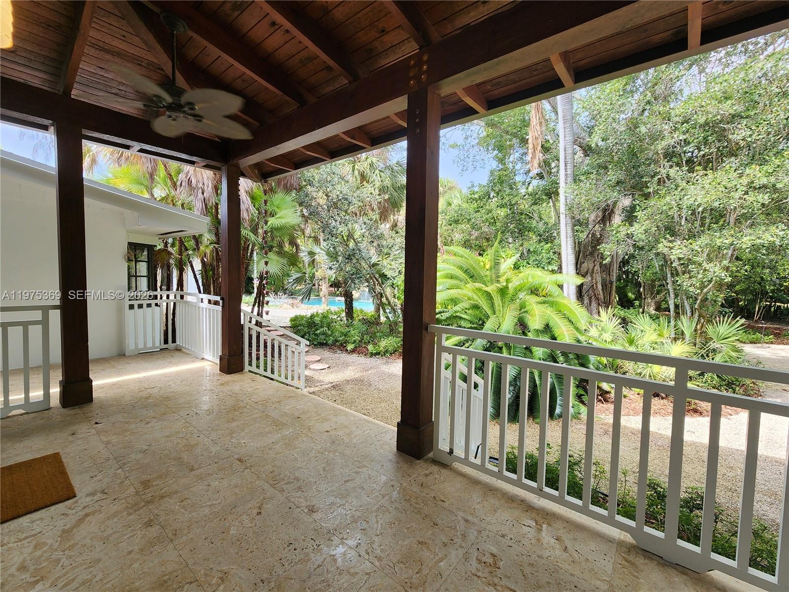 6065 Southwest 133rd Street Pinecrest, FL 33156 - Photo 35 of 41 a view of a porch with garden