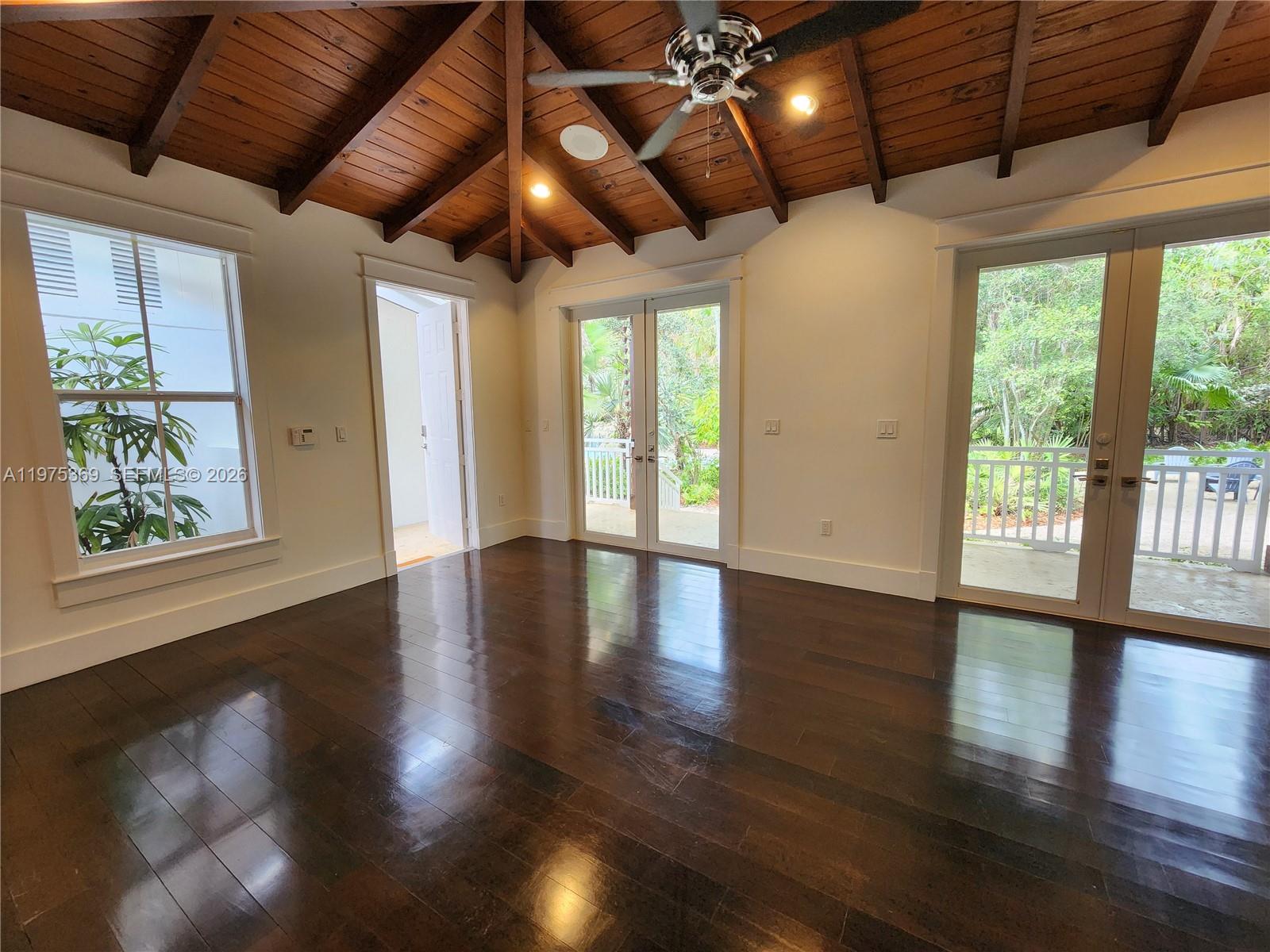 6065 Southwest 133rd Street Pinecrest, FL 33156 - Photo 38 of 41 a view of an empty room with wooden floor and a window