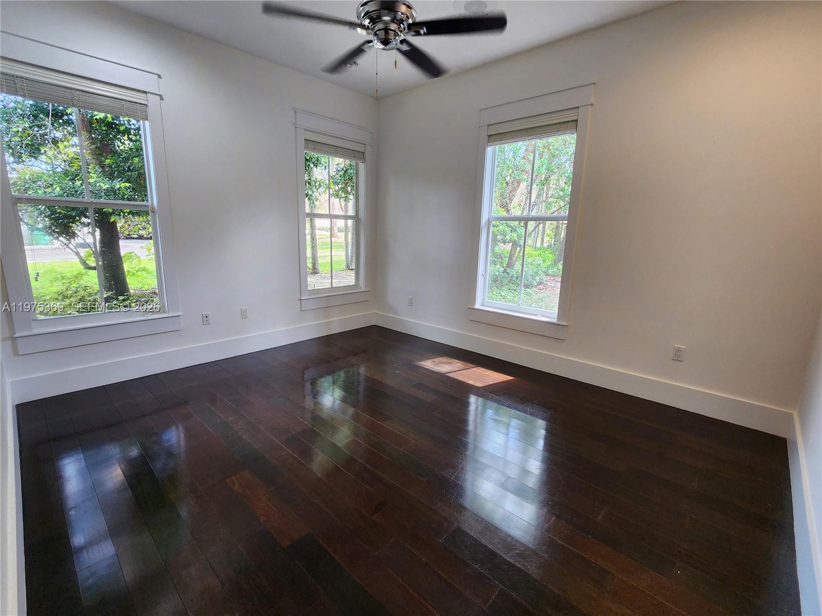 6065 Southwest 133rd Street Pinecrest, FL 33156 - Photo 39 of 41 a view of an empty room with wooden floor and a window