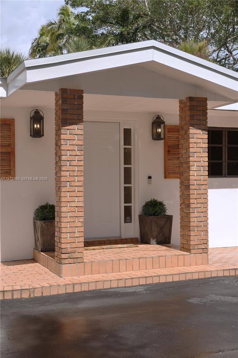 6065 Southwest 133rd Street Pinecrest, FL 33156 - Photo 4 of 41 a view of a house with a garage