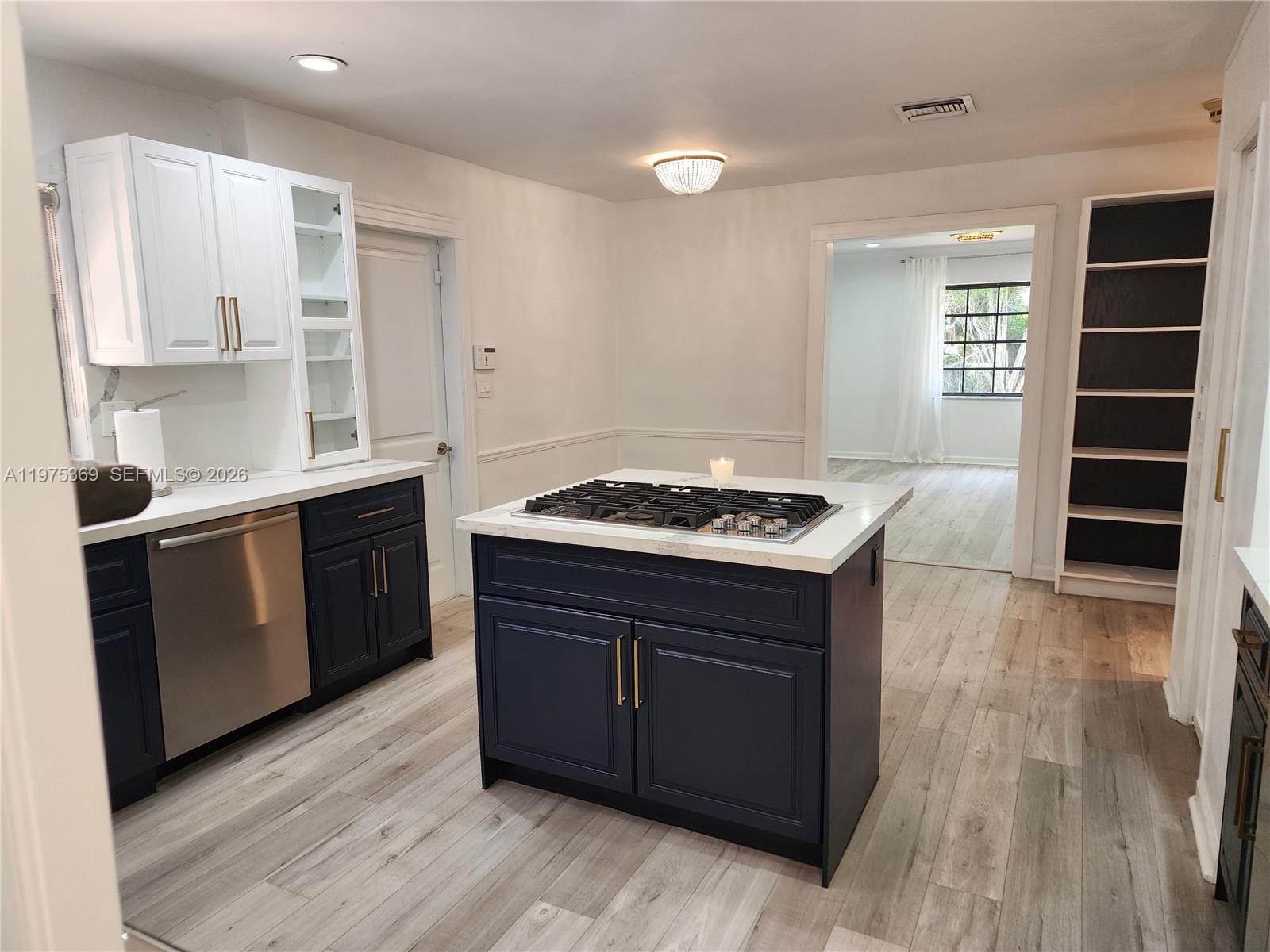 6065 Southwest 133rd Street Pinecrest, FL 33156 - Photo 6 of 41 a kitchen with a stove cabinets and wooden floor