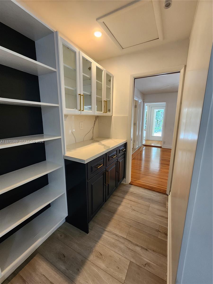 6065 Southwest 133rd Street Pinecrest, FL 33156 - Photo 8 of 41 a large room with wooden floor and windows