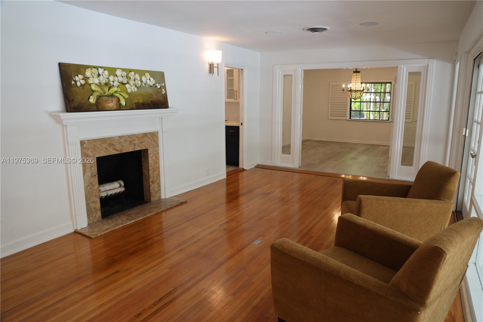 6065 Southwest 133rd Street Pinecrest, FL 33156 - Photo 10 of 41 a living room with furniture and a fireplace