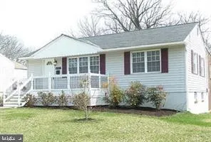 a front view of a house with a garden and yard