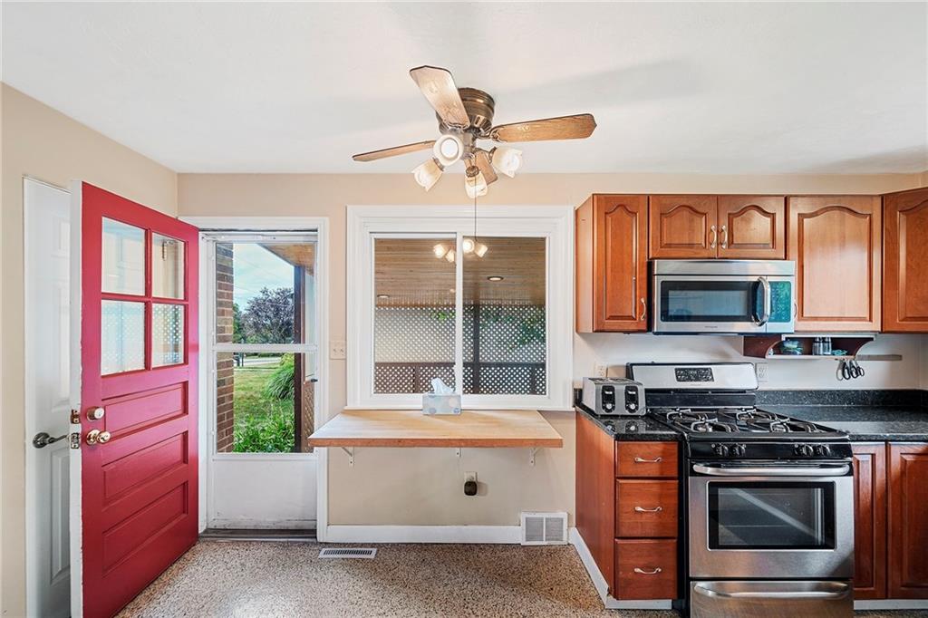 15 Robin Road McKees Rocks, PA 15136 - Photo 17 of 25 Lighted ceiling fan keeping mortgage payment writing on the desk bright & cool. Nice to have the side porch off the kitchen for any grillin'.