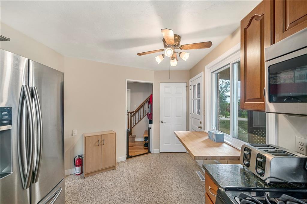 15 Robin Road McKees Rocks, PA 15136 - Photo 18 of 25 Is that a gas stove I see?! Stainless appliances are nice but, wouldn't a wine rack going up that fire extinguisher wall be cool?