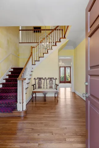 a view of empty room with fireplace and wooden floor