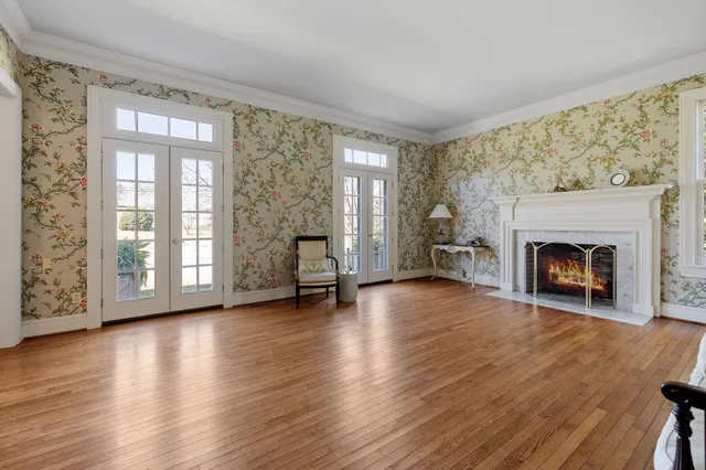 a dining room with furniture a chandelier and wooden floor