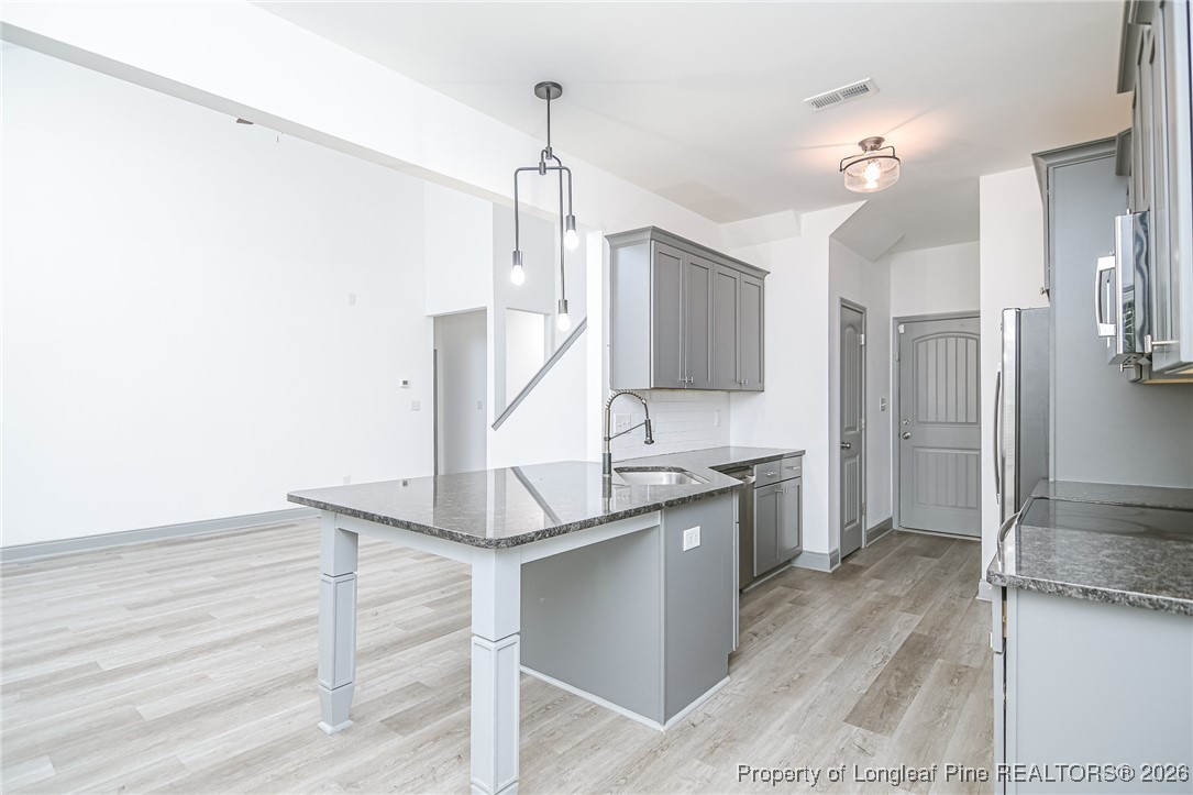 808 Mumford Road Raeford, NC 28376 - Photo 12 of 50 a kitchen with kitchen island a sink stainless steel appliances and cabinets