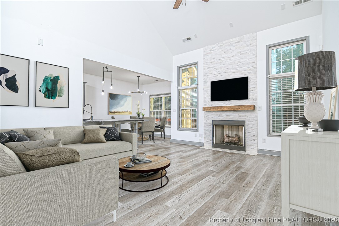 808 Mumford Road Raeford, NC 28376 - Photo 4 of 50 a living room with furniture a fireplace and a flat screen tv